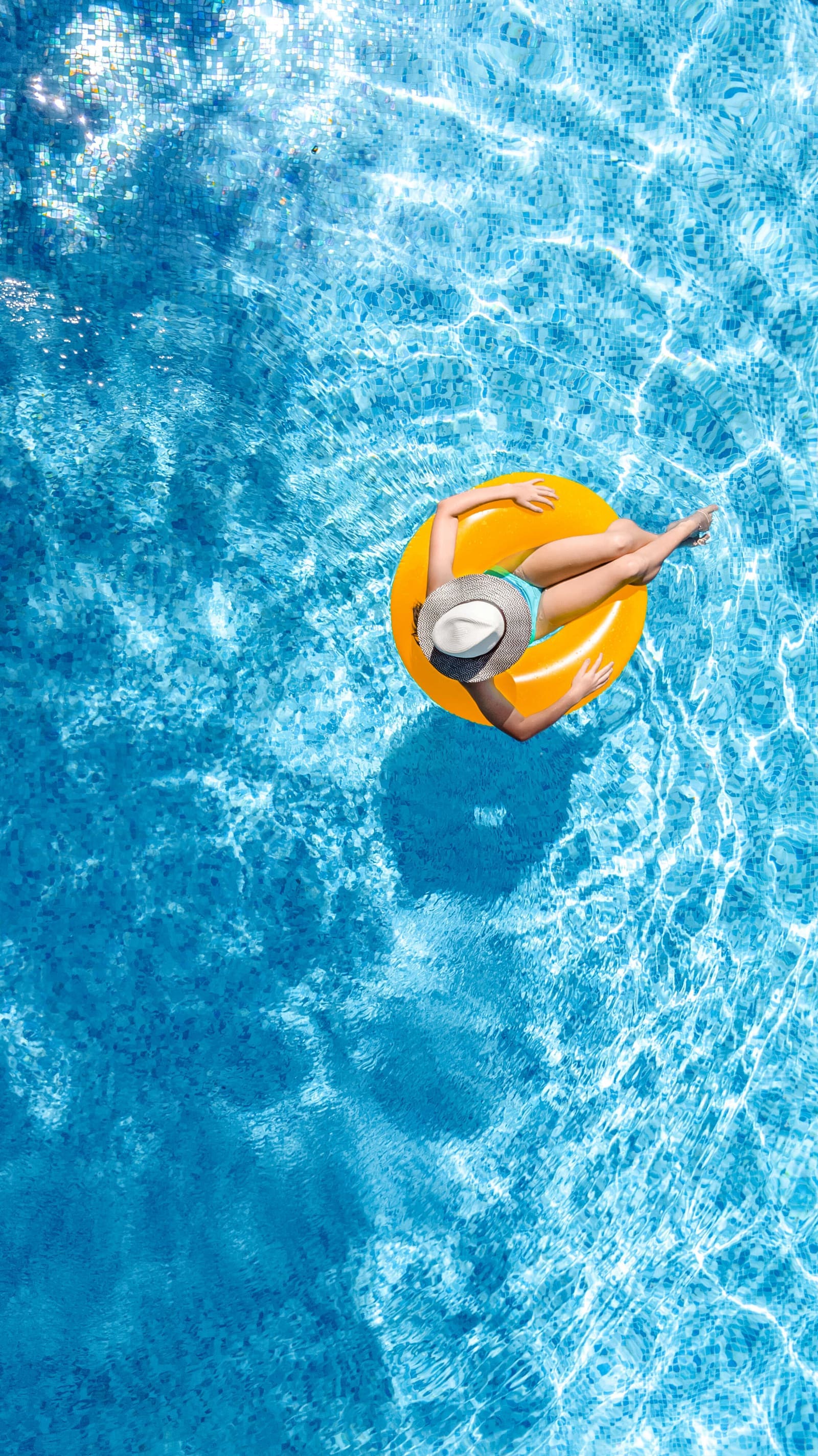 Seasonal pool service planning — residential pool on a sunny day during peak pool-service season