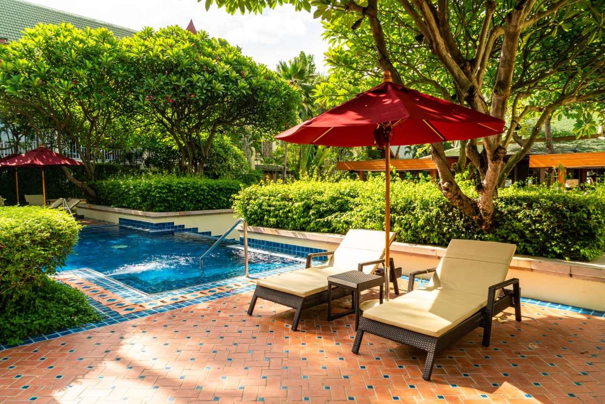Hotel resort poolside beds beside a swimming pool for a vacation setting