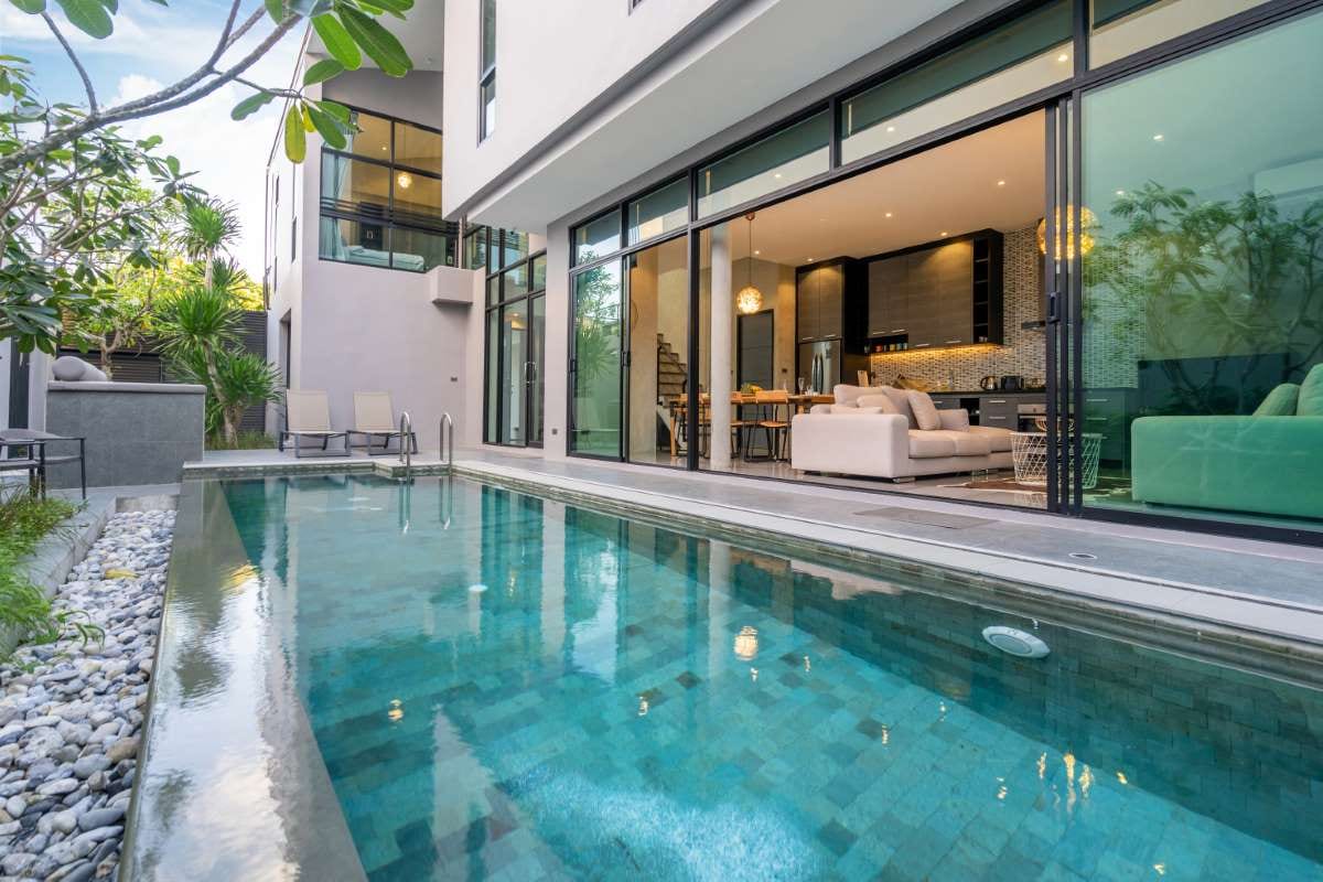 Exterior home with swimming pool and pool house