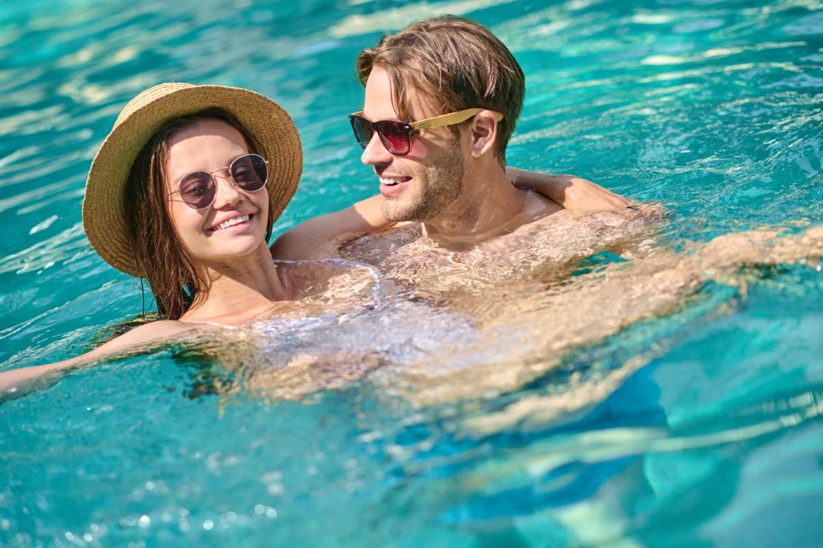Young couple enjoying time together by a swimming pool