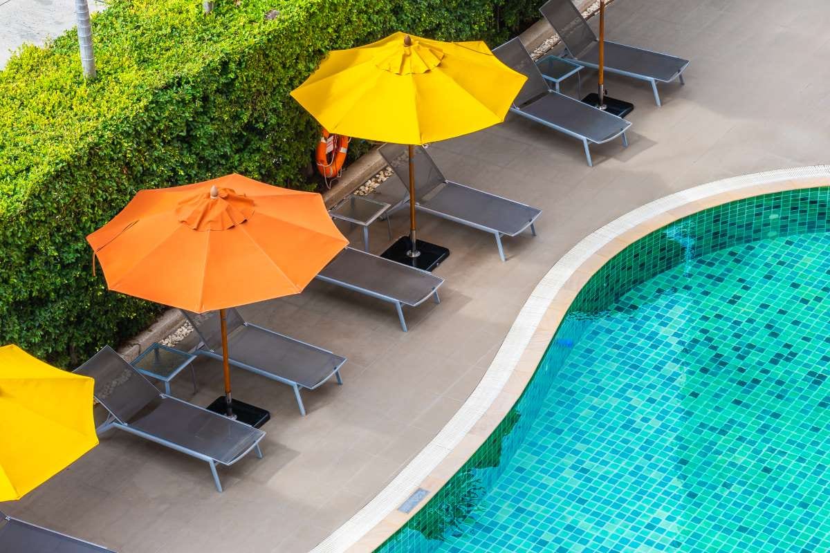 High angle view of lounge chairs beside a swimming pool