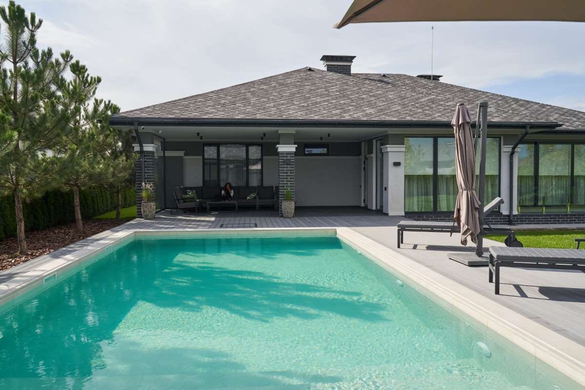 Tropical pool villa exterior and bedroom with lush garden views