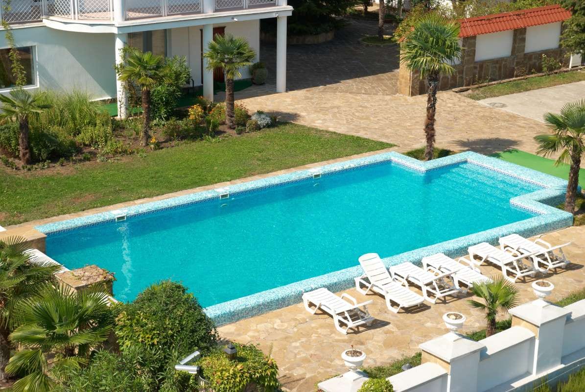 House with a backyard pool for a pool care billing article