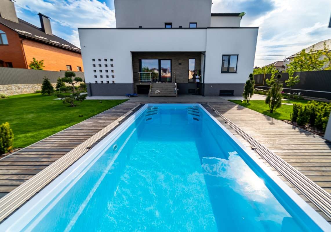 Luxurious house garden with a clean water pool and natural landscaping