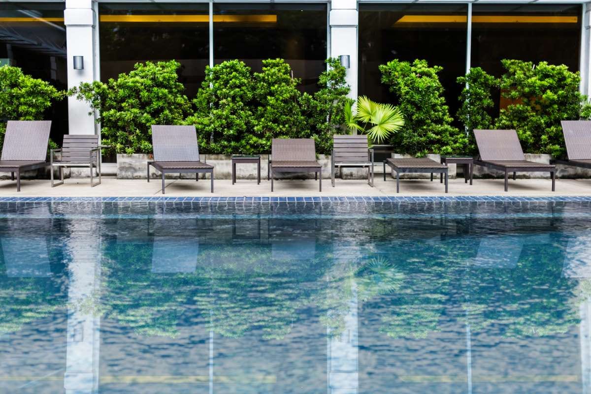 Pool stairs beside a garden, suggesting a backyard pool setting