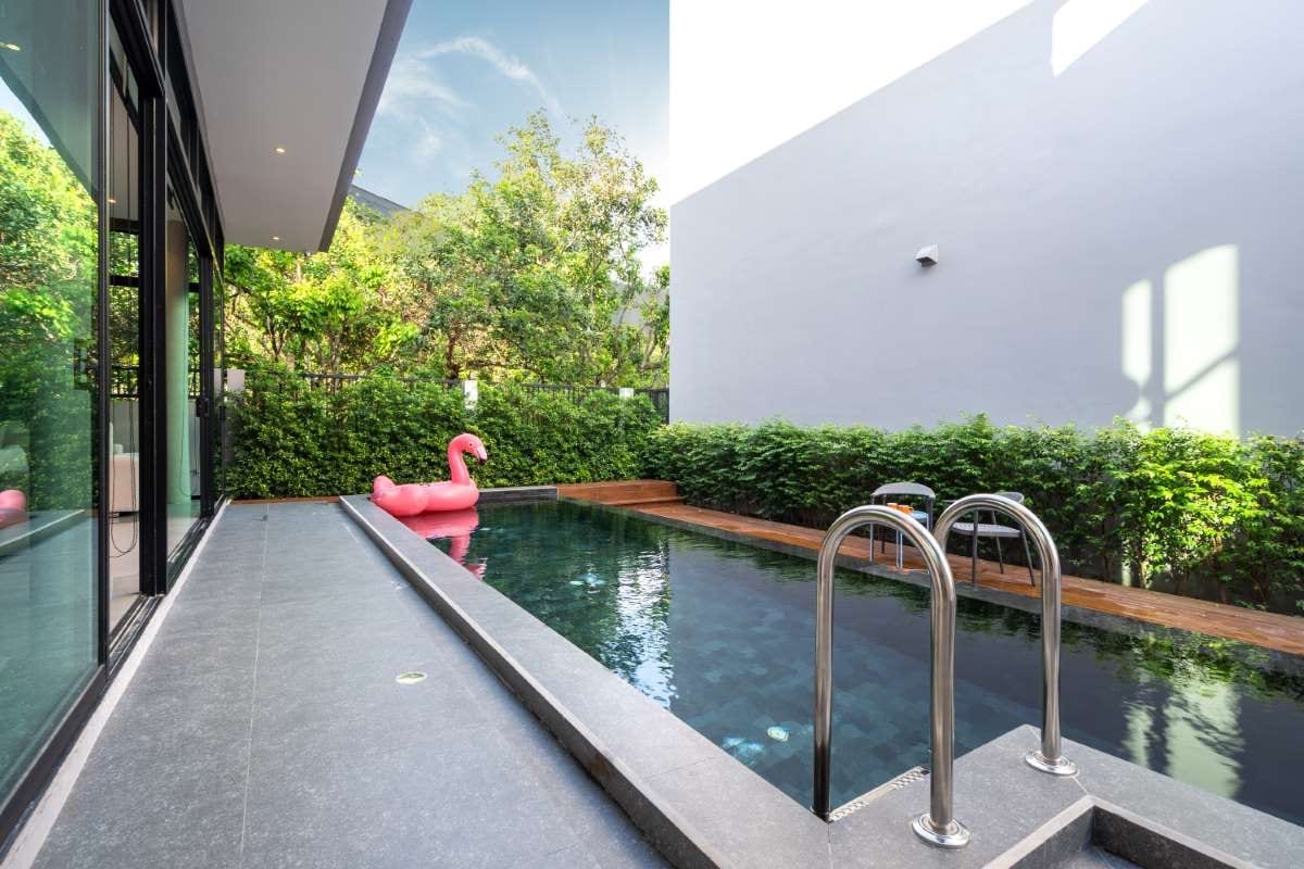 Pink floating duck in an infinity pool beside a pool terrace