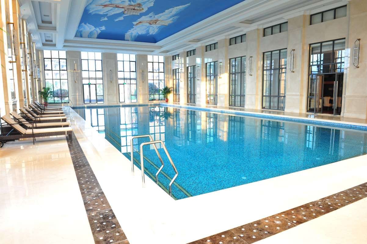 Spacious bright indoor swimming pool for a carbon-neutral pool service business plan