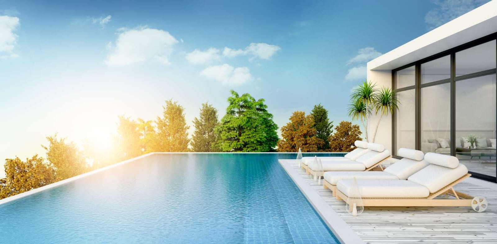 Sun loungers beside a private swimming pool on a sunny beach deck