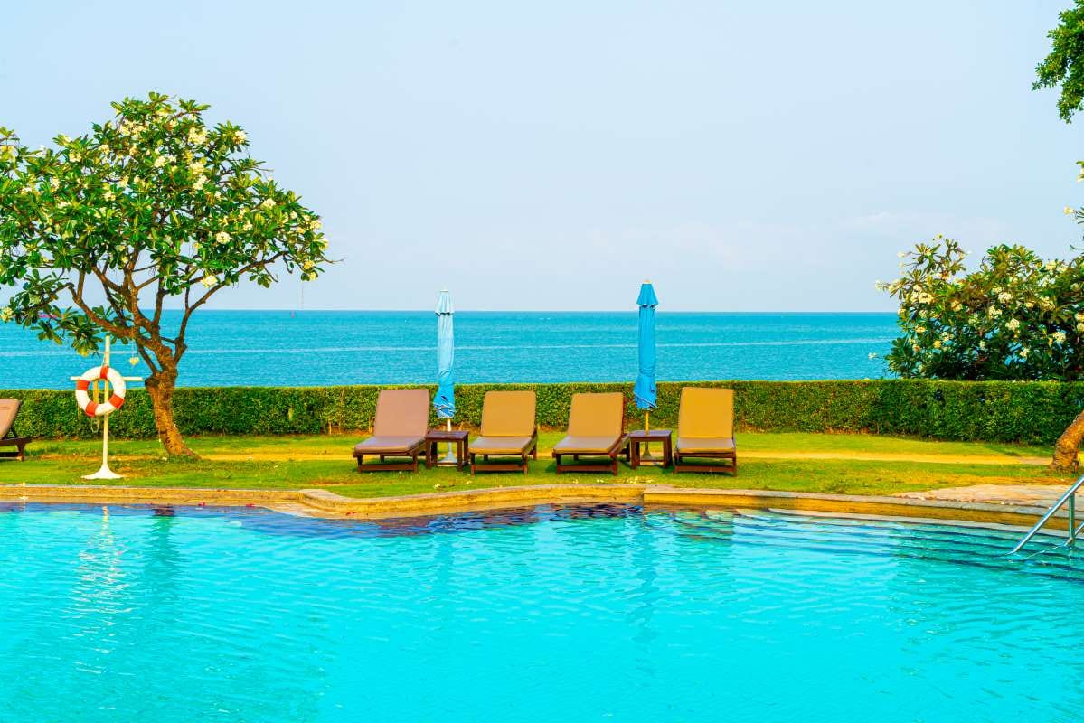 Sun beds and umbrellas around a swimming pool