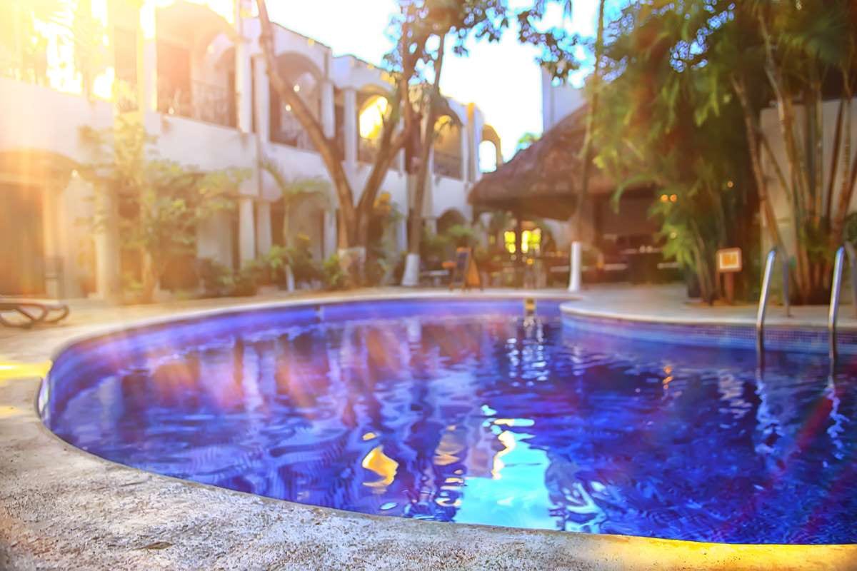 Sun loungers by a sunny pool on a summer vacation day
