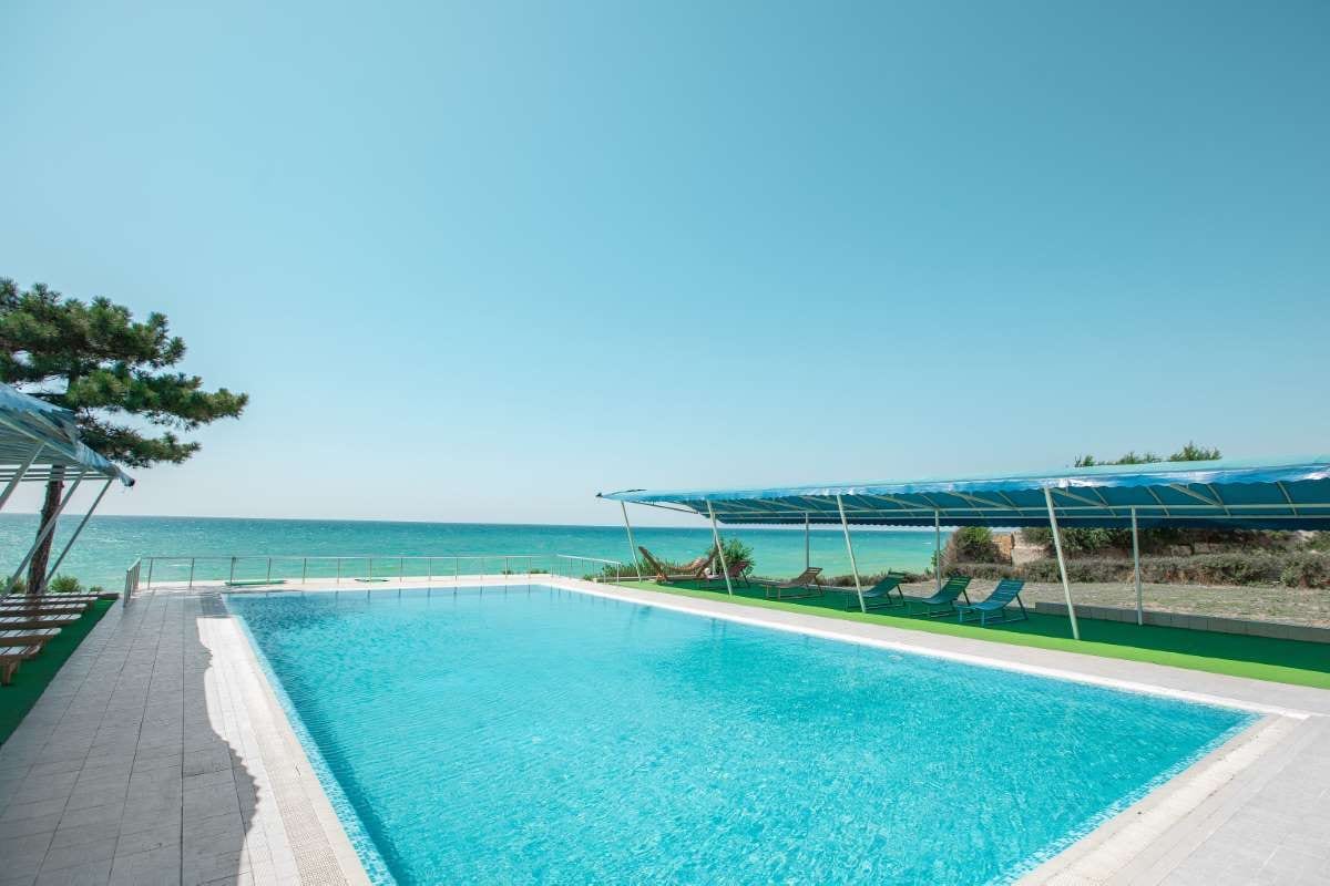 Swimming pool tourist area with seating and lounge chairs